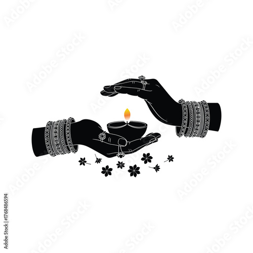 Hands holding a diya oil lamp with bangles and rings symbolizing diwali celebration and tradition