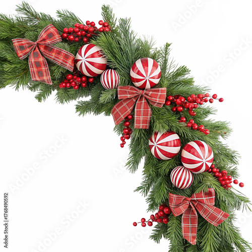 Festive christmas garland decor with red bows candy ornaments and berries on evergreen branches