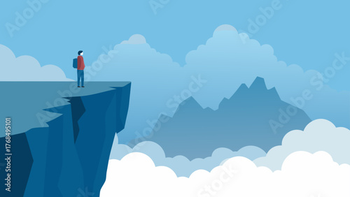 Lone hiker stands on a cliff edge overlooking misty mountains and clouds