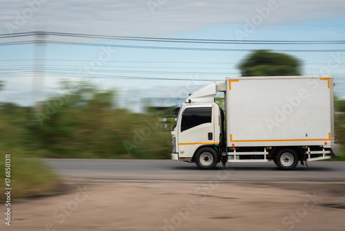 Side view of a small truck driving on a country road, truck running on the road, small truck on the road.