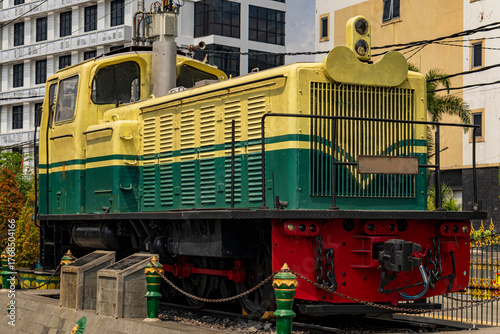 Vintage Green and Yellow Diesel Locomotive Displayed Outdoors with Industrial Design