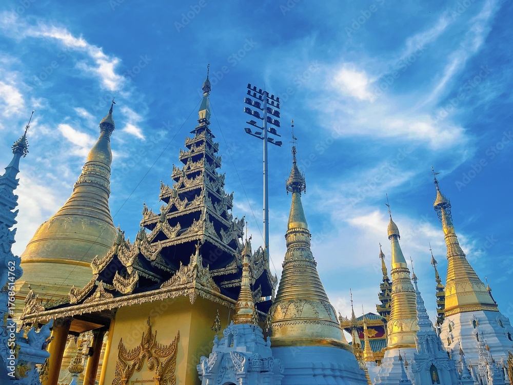 Naklejka premium Shwedagon Pagoda in Yangon Myanmar, Famous Golden Buddhist Temple Landmark with Blue Sky