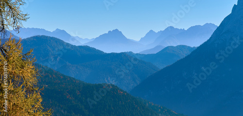 Tableau sur toile Autumn landscape with endless chain of mountain ridges in a sunny day in the Dolomites, Italy