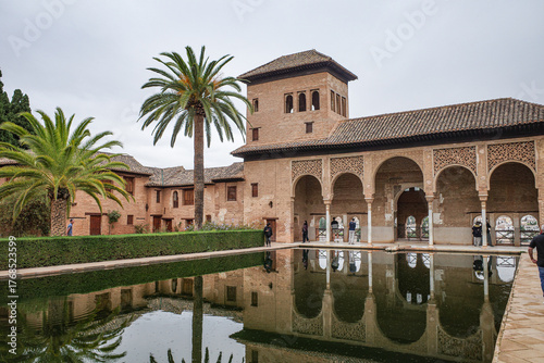 Granada, Spain - 21 Oct 2025: Partal Palace and pond at the Nasrid Palaces, Alhambra