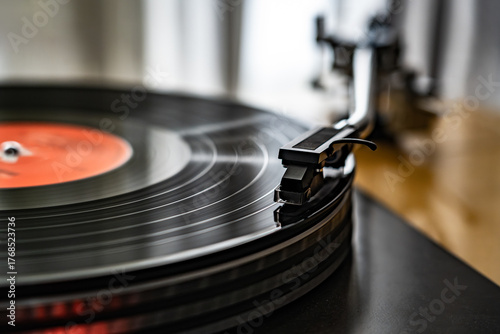 Photography Close-up of spinning vinyl record on turntable, capturing motion of grooves and stylus