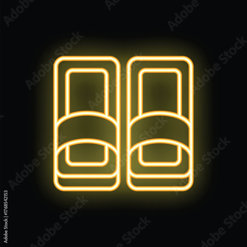 Neon sign representing a pair of slippers glowing yellow on a black background