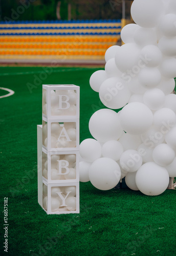 Transparent boxes with balloons and Baby sign for gender reveal party