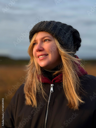 Thoughtful Young Woman Looking Away in Autumn Nature at Sunset