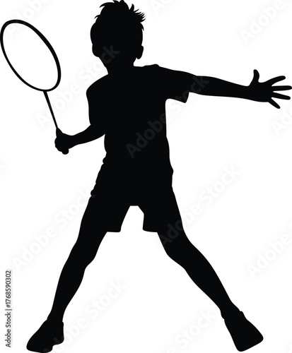 Silhouette of a young boy playing badminton in a dynamic pose with a racket