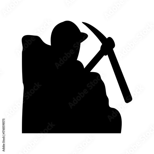 Silhouette of a Miner with Pickaxe Working Hard in the Darkness