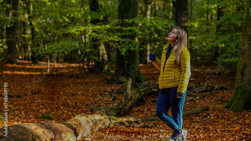Slavic Woman Enjoying a Moment of Reflections in a Forest Covered with Autumn Leaves