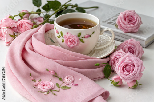 cup of tea and pink rose