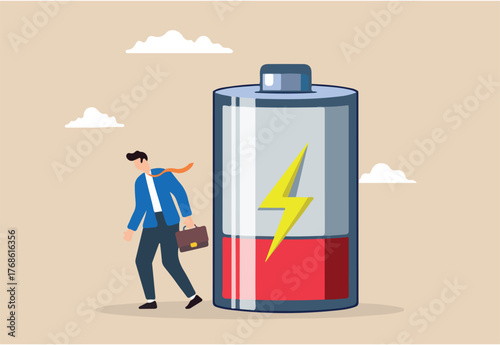 Tired businessman with low battery illustrating exhaustion, fatigue, and burnout resulting from hard work. Concept of stress, anxiety, and potential depression from unhealthy work habits