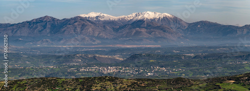 Snow capped Mount Psiloritis in Crete overlooking green valleys and villages