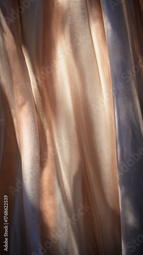 Soft beige and gold fabric texture with flowing folds, concept of elegance, luxury and minimal design.