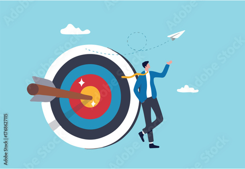 Business objective, purpose or target, goal and resolution to aim for success, aspiration and motivation to achieve goal concept, confident businessman stand with arrow hit bullseye on archery target