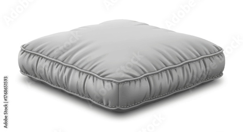 A square gray cushion sits on a white surface casting a shadow.