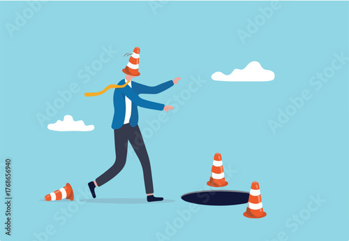 Go to Page
|1234Next
Blind and frustrated business direction, mistake or failure, trap or crisis ahead, risk and uncertainty concept, blindfold businessman cover with pylon walking to fall into the ho