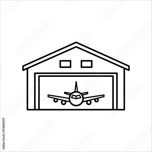 Airplane inside a hangar with open doors
