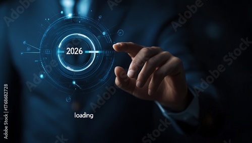 Businessman finger touches futuristic loading bar with year 2026 and text loading hand touching