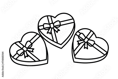 Three heart-shaped boxes of chocolates are tied with ribbons and bows.