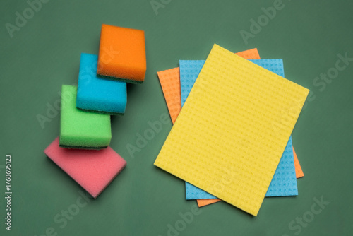 Multicolored cleaning micro fiber cloth and cleaning sponges isolated on yellow background