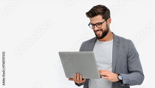 Young Man in Casual Clothing Smiles While Using Laptop Indoors