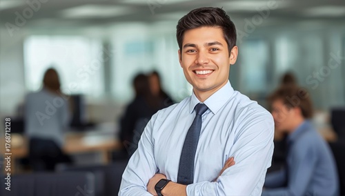 Young Professional Smiling Confidently in a Modern Office Setting During Dayt...