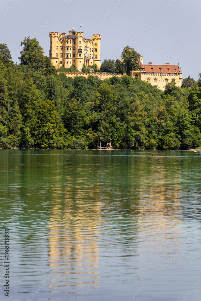Obraz premium Experience the stunning view of Hohenschwangau Castle surrounded by lush nature in the German Alps
