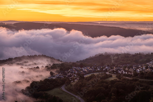 Stunning sunrise over the Rhine River near Bad Salzig, Germany, showcasing layered clouds and peaceful valleys