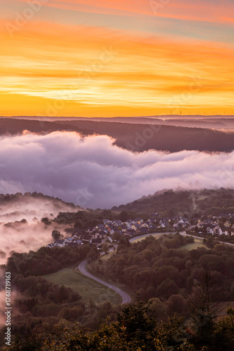 Stunning sunrise over the Rhine River in Bad Salzig, Germany with misty valley and glowing sky