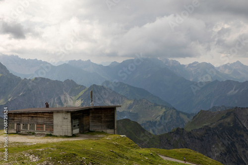 Old rustic building on Nebelhorn with stunning mountain views surrounded by the German Alps on a cloudy day