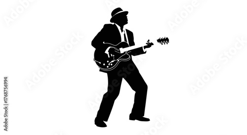 Photography Silhouette of a guitar player in a suit and hat performing a jazz music show