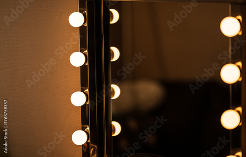 Fotografie Illuminated dressing mirror in dark backstage room.