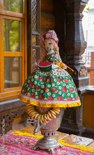 Russian samovar with bagels and a doll on the samovar
