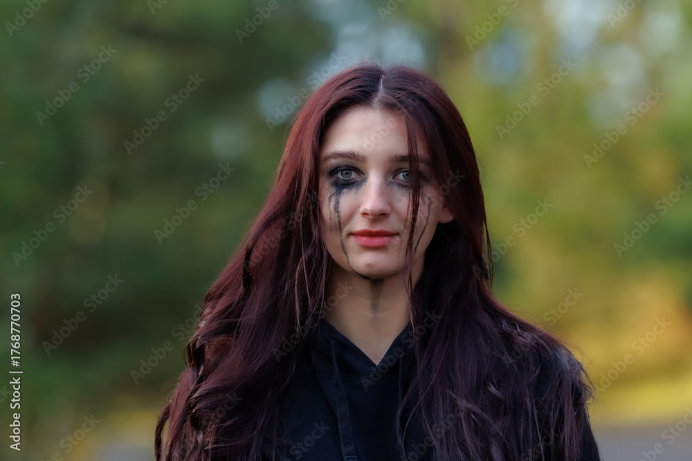 Naklejka premium Cinematic Portrait with Smeared Makeup in Autumn