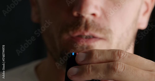Close-up. Man speaks into a wireless microphone recording audio . Selective focus.