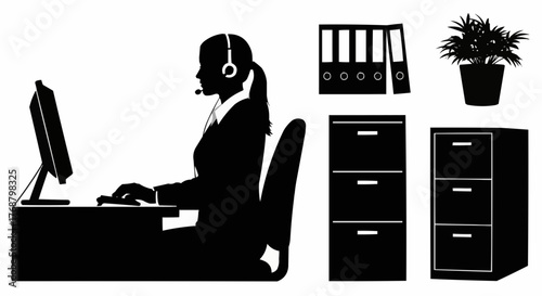 Silhouette of office worker with headset at desk with computer and office storage furniture shown