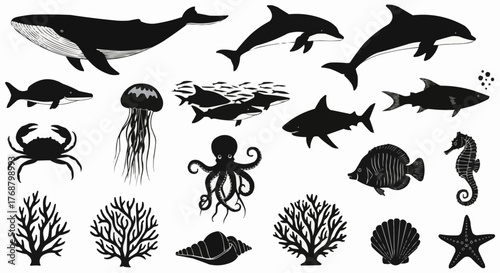 A collection of black and white sea creatures including a whale, sharks, and coral formations