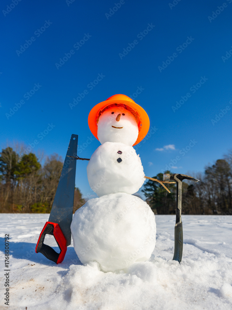 Obraz premium Snowman with winter hat and scarf outdoors. Snowman in winter landscape. Snowman with snowball fun outdoors.