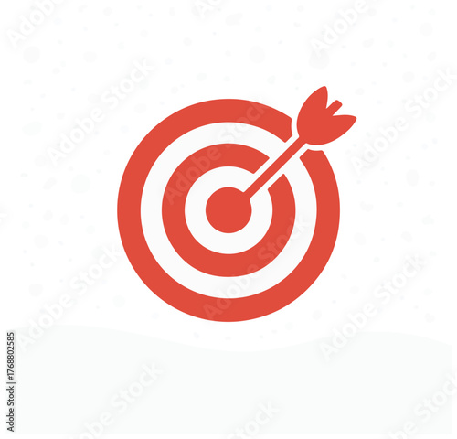 Red and white archery target with arrow in bullseye on snowy background