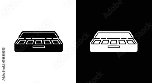 A graphic illustration of an open makeup or paint palette with several wells, presented as a black icon on a white background and a white icon on a black background.