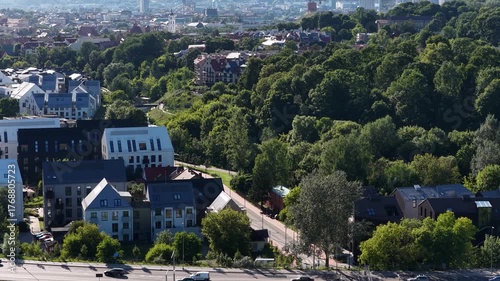Wallpaper Mural Aerial view of Paupys district in Vilnius, Lithuania, showing modern residential buildings, river, and historic old town architecture surrounded by greenery. Torontodigital.ca