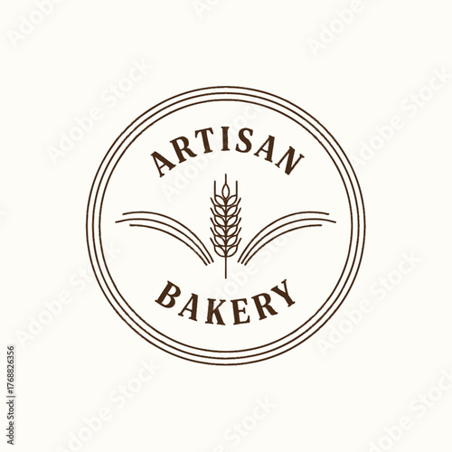 A circular emblem for a bakery, with the words "Artisan Bakery" and a wheat stalk