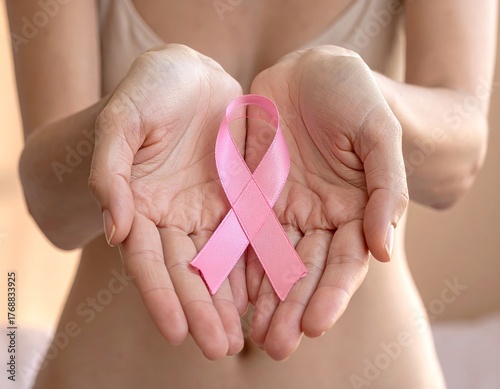Female Hands Holding a Pink Ribbon – Symbol of Breast Cancer Awareness, Hope, and Support