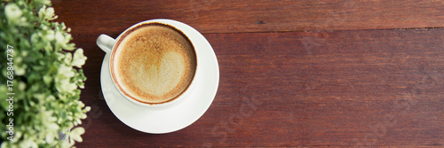 Fototapet Banner Close up woman hands holding disposable paper coffee cup drinking outdoor in green park bokeh blurred background