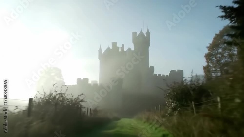 Castle shrouded in mist on path through woods, for fantasy, history, or book cover uses