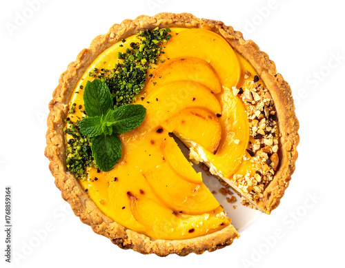 Delicious peach tart with custard, mint, and pistachio from above, with a slice missing
