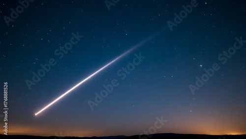 A brilliant meteor streak with a glowing tail in a star-filled night sky.