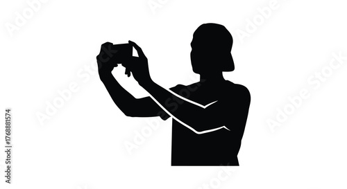 A person holding a camera and taking a picture in a striking black silhouette against a white background silhouette